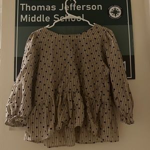 Blu pepper Large tan poka dotted blouse with black ribbon on the back.